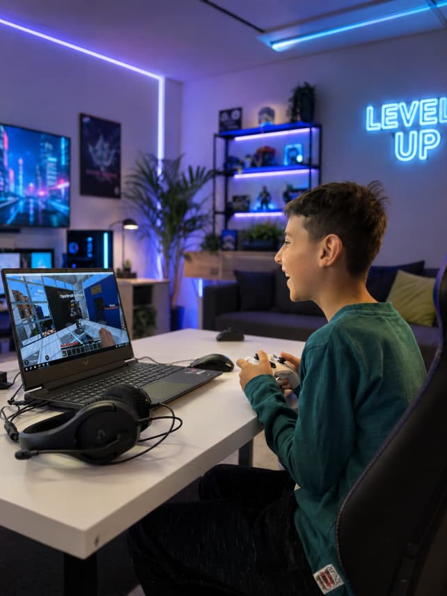Young person gaming with a controller at Player Ready venue
