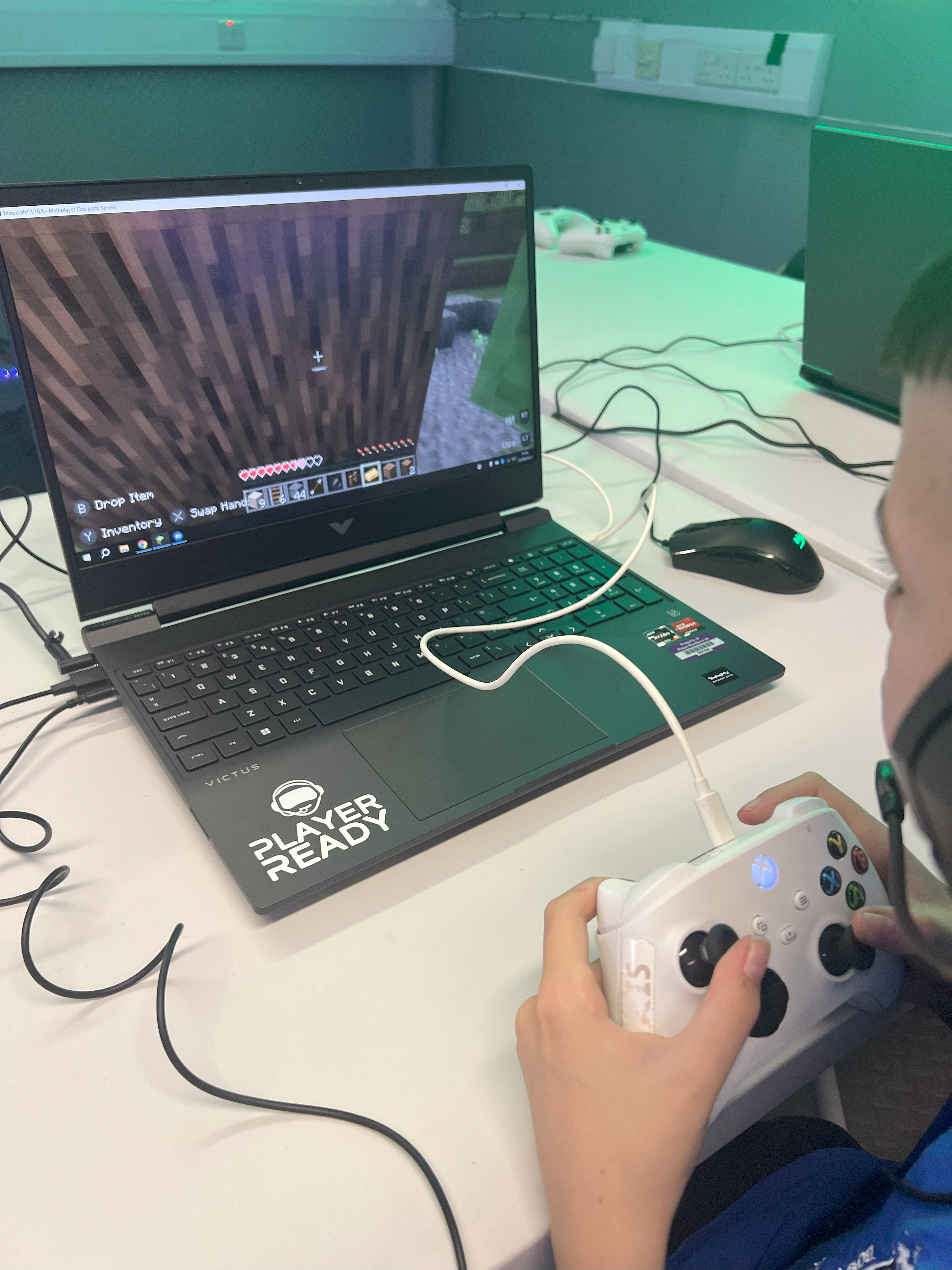 Young person playing Minecraft on a laptop at Player Ready
